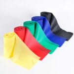 Five UNIBAND exercise band rolls in yellow, red, green, blue and black