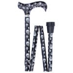 Classic Canes Foldable Skulls Cane — partly folded showing the derby handle and shaft covered in a black background with white skulls pattern, a small silver collar between handle and shaft and a black rubber ferrule at one end