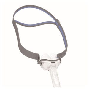 ResMed AirFit P10 Nasal Pillows Mask — small clear-and-white nasal pillow mask with white pillows facing the camera, attached to a slim grey headgear with blue piping and a short ribbed vent tube hanging from the front of the mask