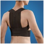 Black Mediroyal Posture brace worn on a bare back with the straps crossing between the shoulder blades