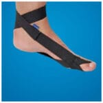 Mediroyal hallux valgus band in black fitted on a foot against a blue background
