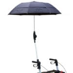 Black umbrella on a jointed arm clamped to the handle of a silver rollator