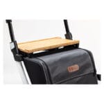 Close-up of the bamboo tray resting on the frame above a black rollator bag