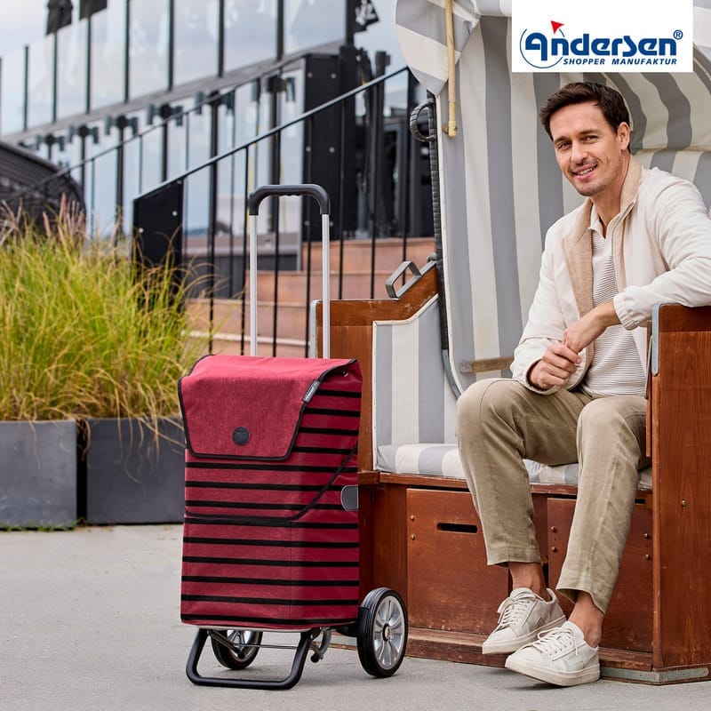 Person with the bordeaux Andersen Alu Star Jelke shopping trolley