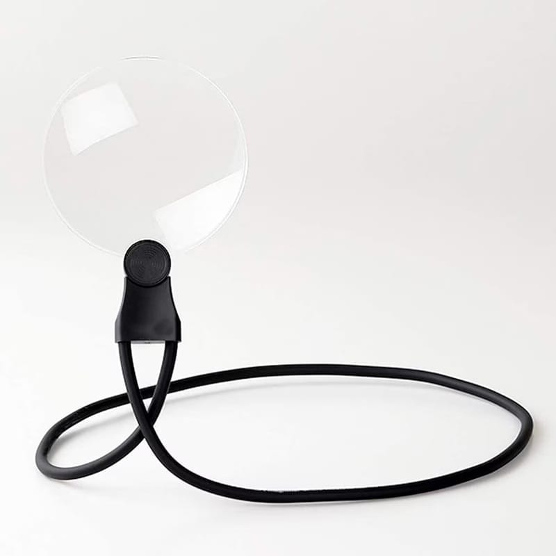 Round RBP neck magnifier lens on a long black bendable strap curled on a white surface
