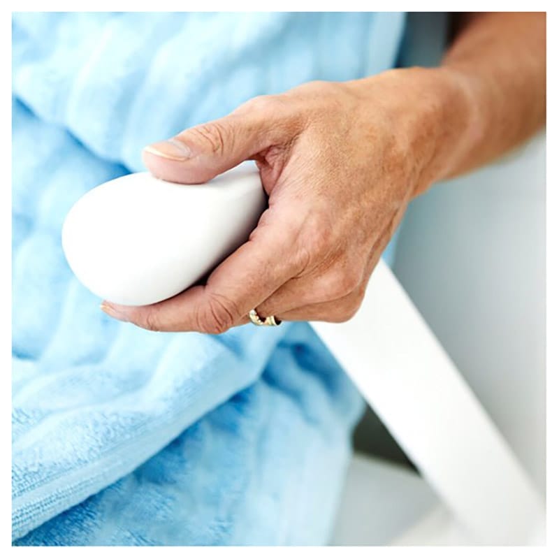 Hand gripping the rounded end of the fold-up armrest