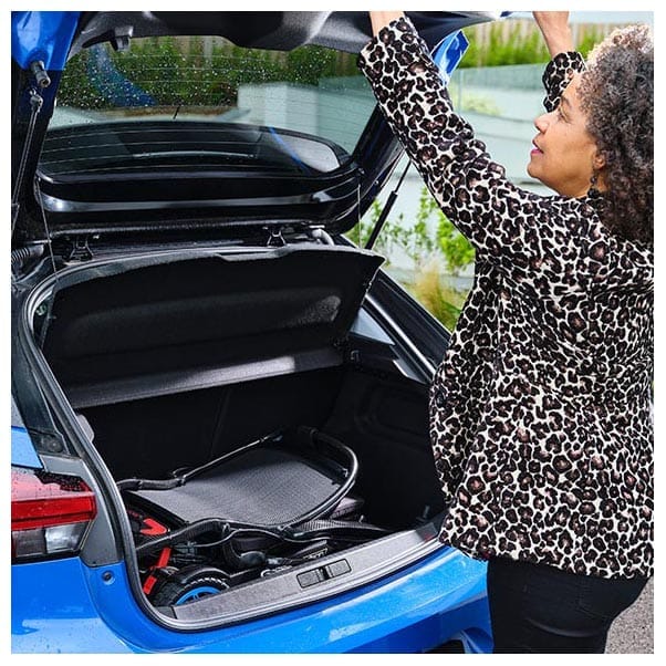 Folded Q50 R Carbon standing in the boot of a blue hatchback