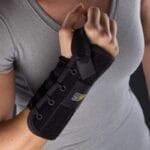 Mediroyal Nea Stabil wrist brace Mediroyal Nea Stabil wrist brace in black with lacing and wide Velcro strap, worn on the right forearm
