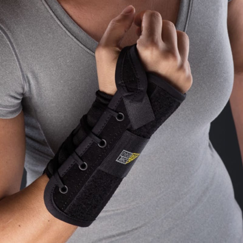 Mediroyal Nea Stabil wrist brace Mediroyal Nea Stabil wrist brace in black with lacing and wide Velcro strap, worn on the right forearm