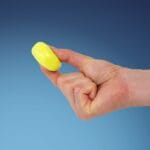 Yellow putty pinched between thumb and index finger