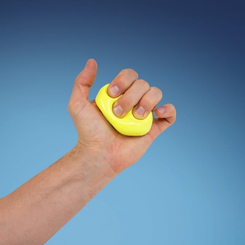 Yellow putty squeezed in a clenched fist