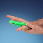Green putty rolled into a roll between the fingers