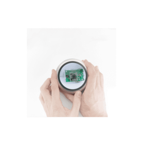 Two hands holding the magnifier over a green circuit board