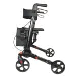 Folded rollator with the bag removed The rollator folded across its width next to the removed bag
